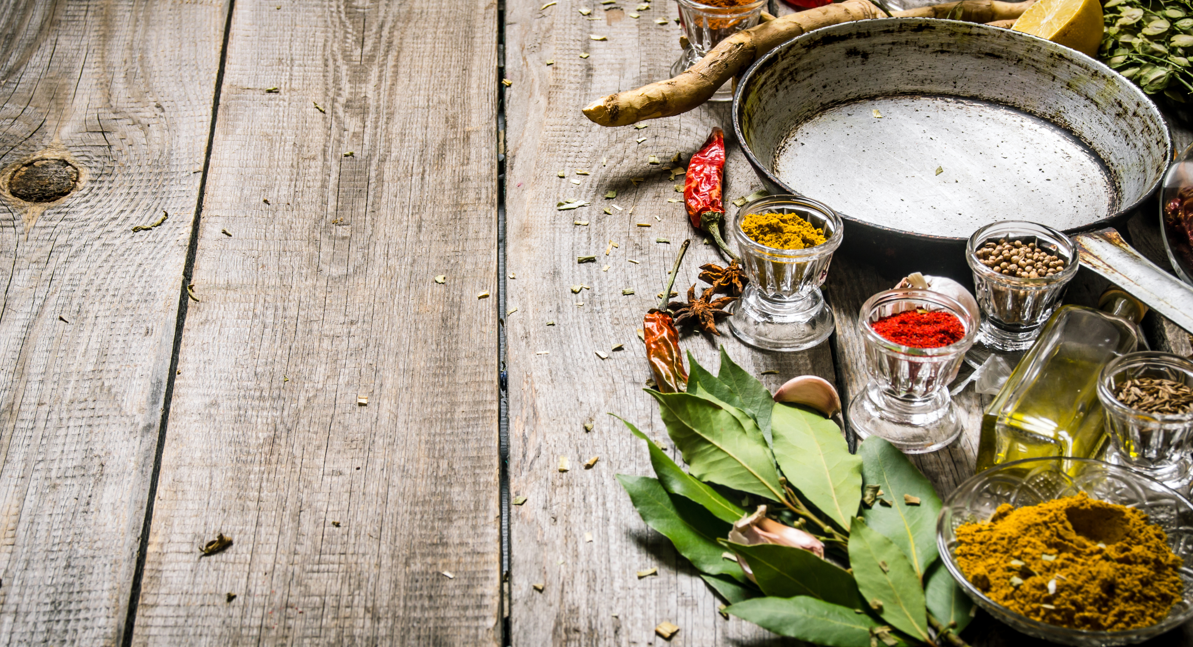 Ginger, spices and bay leaves on a wooden table