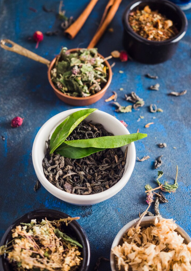 Dried kitchen herbs and fresh leaves